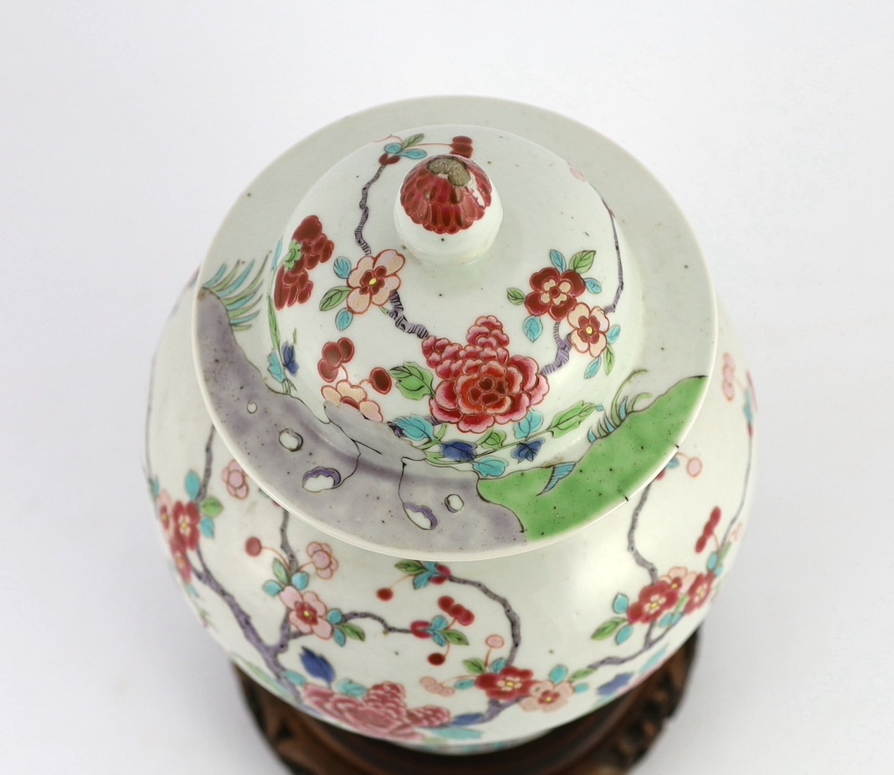 A Chinese famille rose fencai 'pheasant' vase and cover, 19th century, Jiaqing-Daoguang period, 28cm high, small faults to cover, wood stand